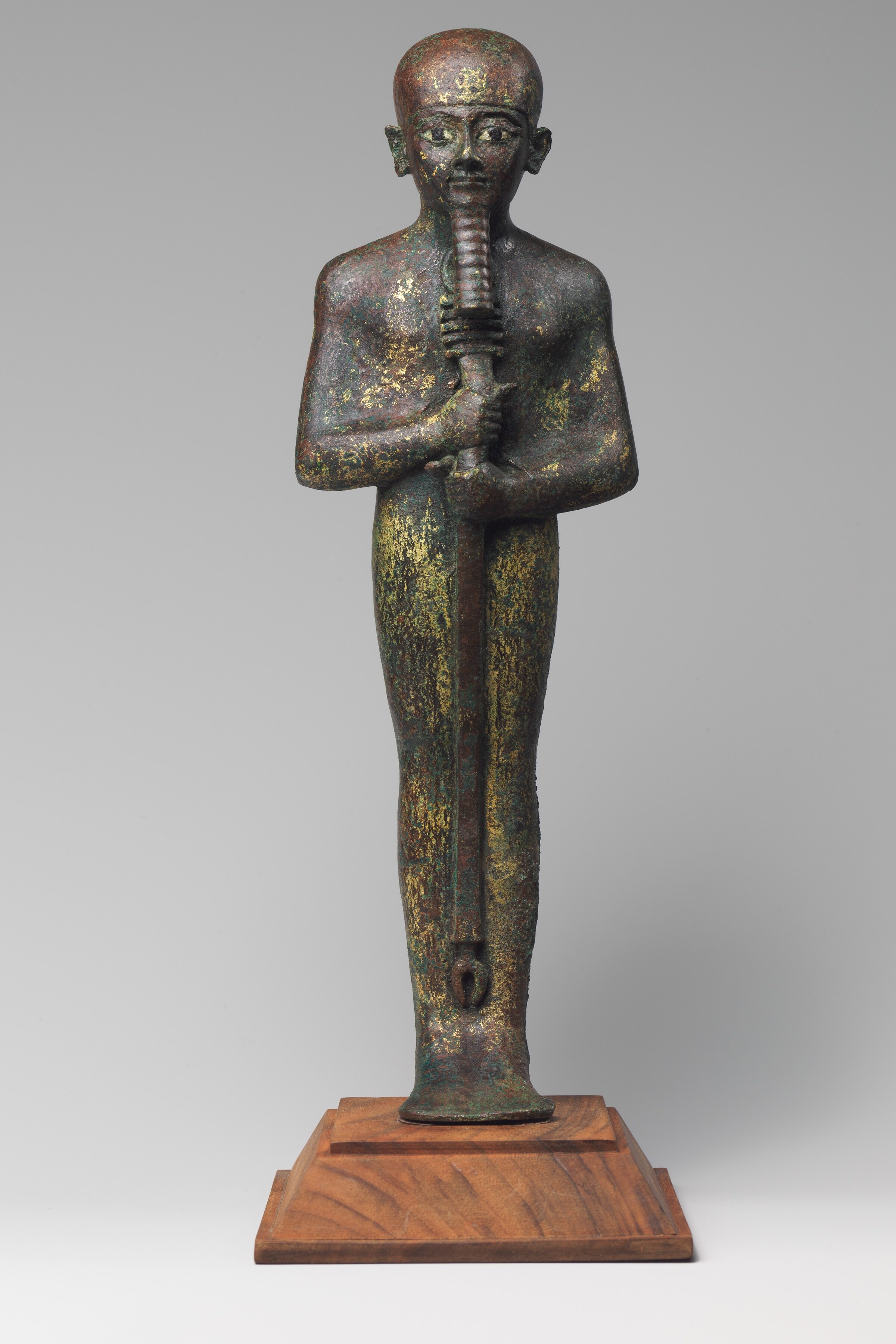 Bronze statue of the Egyptian god Ptah, shown mummiform with a tight cap and straight beard, holding a scepter