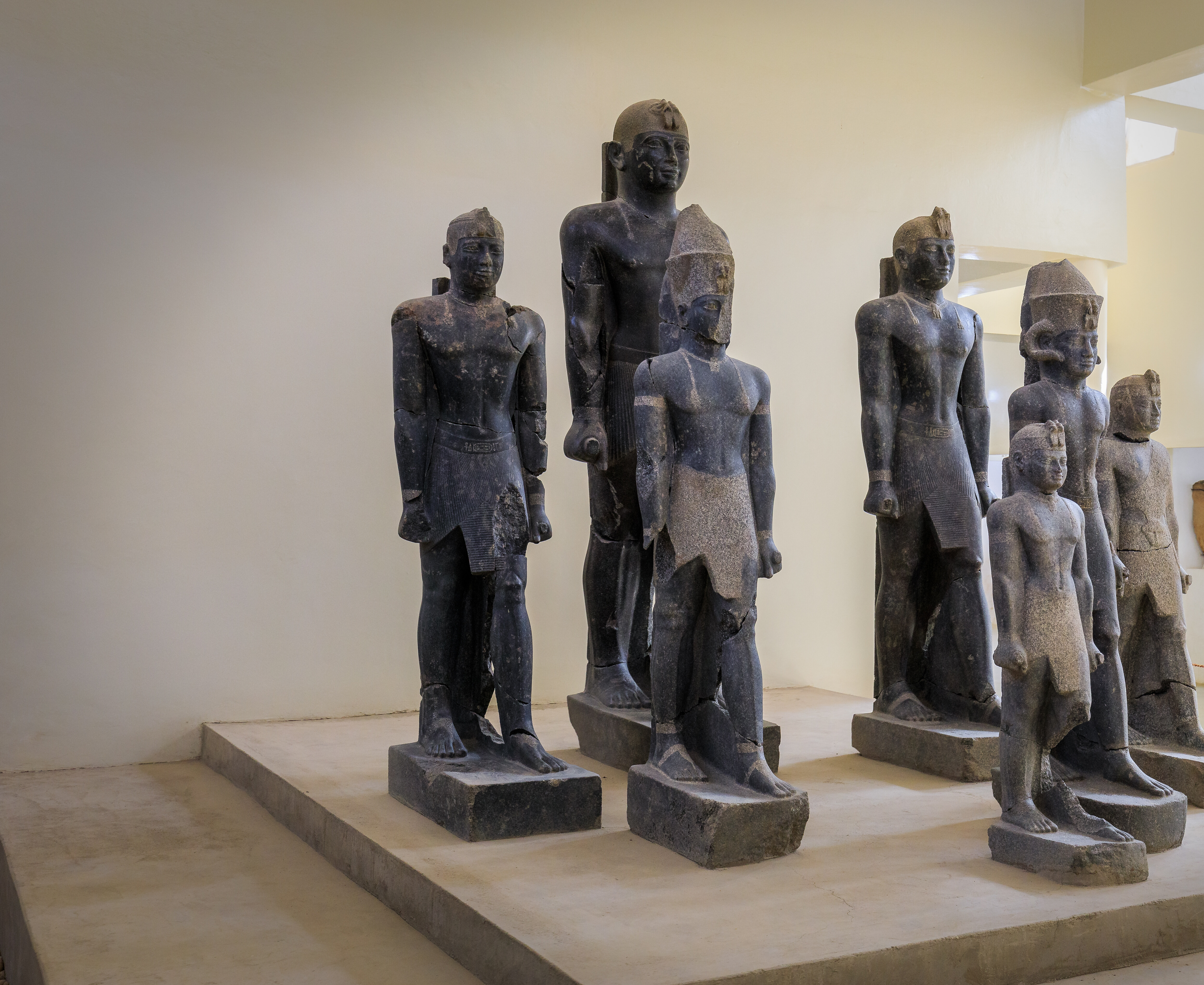 Seven black granite statues of Kushite kings, including Taharqa, Senkamanisken, and Aspelta, on display at the Kerma Museum in Sudan